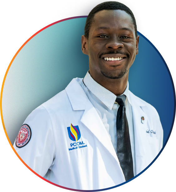 Smiling PCOM medical student in a white coat and tie against a gradient blue background