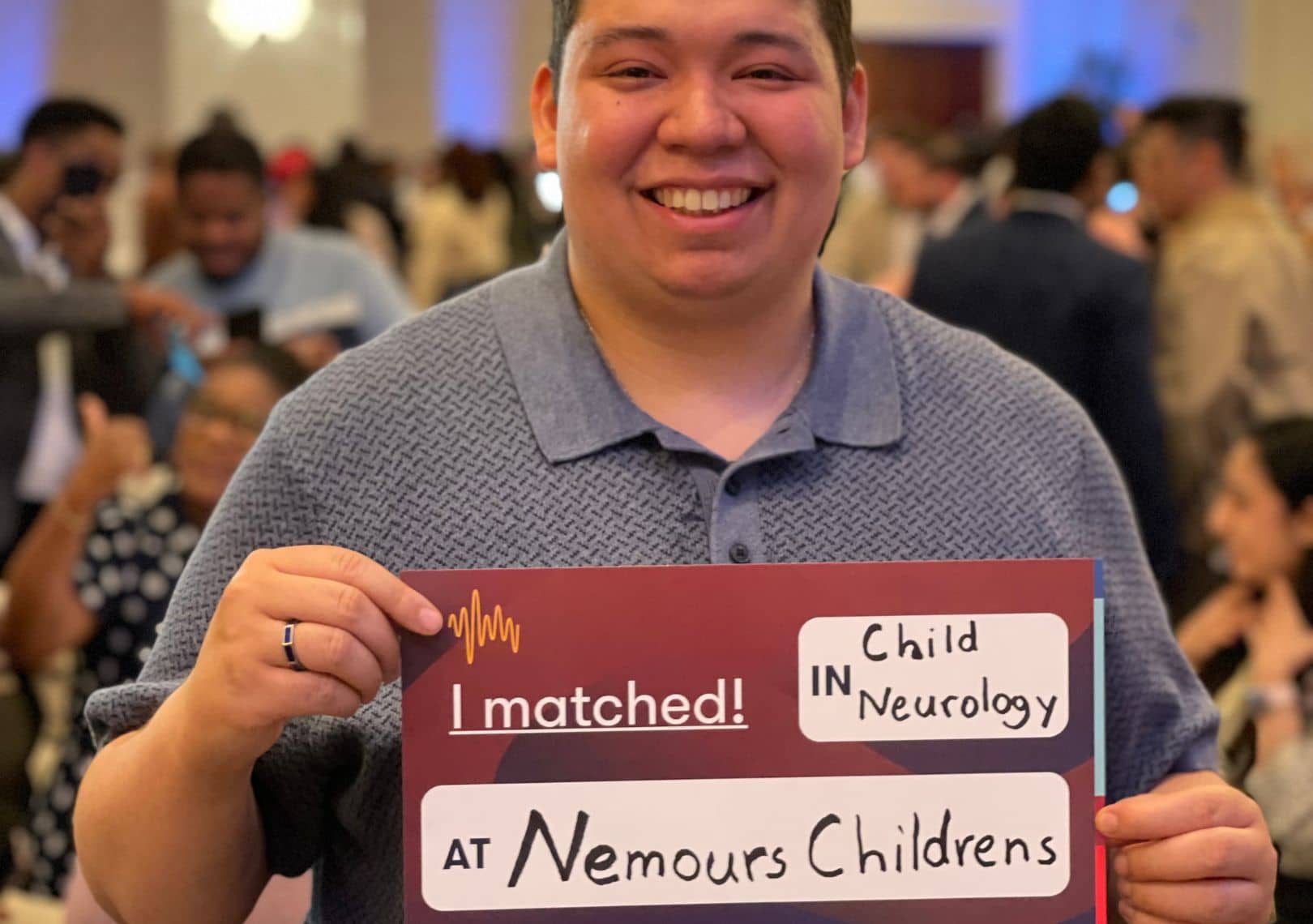 Smiling student holding an 