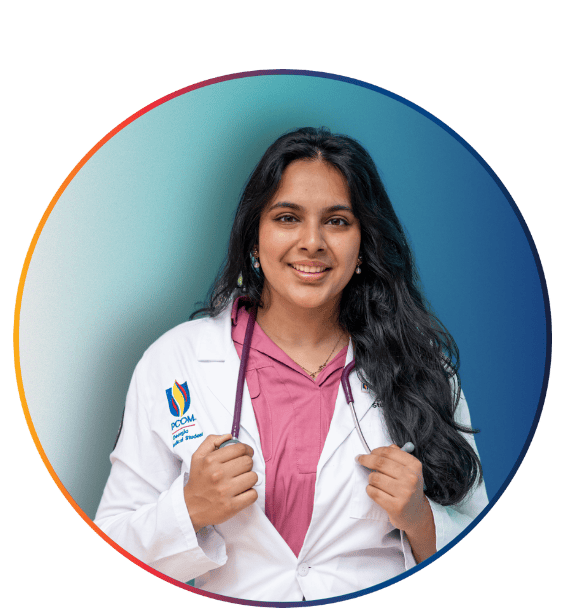 PCOM student physician in a white coat and pink scrubs with a stethoscope smiling in a circular portrait with a gradient border
